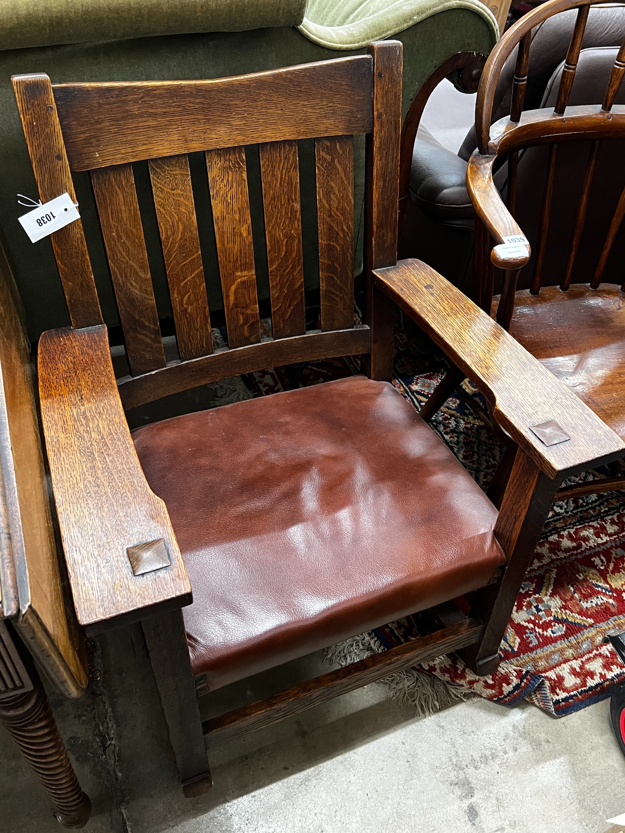 An early 20th century Stickley oak rocking chair, width 66cm, depth 50cm, height 86cm